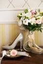 Wedding decoration: shoes, rings and bouquet on a table Royalty Free Stock Photo