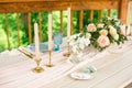 Wedding decoration table in the garden, floral arrangement, candles in the style vintage on outdoor. Wedding cake with flowers. Royalty Free Stock Photo