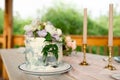 Wedding decoration table in the garden, floral arrangement, In the style vintage on outdoor. Wedding cake with flowers Royalty Free Stock Photo