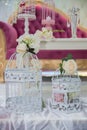 Wedding decoration. Two old ornamental cages decorated with colorful flowers. Two white decorative bird cages filled with flowers