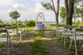 Wedding decoration of white chairs, arc of flowers awaits its bridegroom.