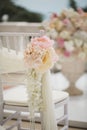 Wedding decorations flowers on chairs. Wedding exit registration, white chairs decorated for wedding. wedding setup