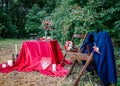 Wedding decorations outdoors. Decorated table with a burgundy tablecloth for a romantic dinner. Royalty Free Stock Photo