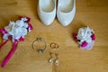 Wedding detail. Accessories for the bride. Shoes rings earrings bracelet and boutonniere Royalty Free Stock Photo