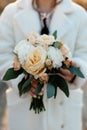 Wedding details. Close up of female hands holding bridal bouquet. winter wedding Royalty Free Stock Photo