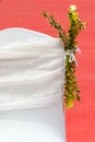 Decorative flowers on white chair covers. Royalty Free Stock Photo