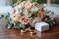Wedding details grooms bouquet, gold rings, cufflinks on wooden background