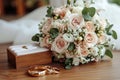 Wedding details grooms bouquet, gold rings, cufflinks on wooden background