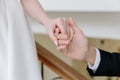 Wedding details. Hands of the newlyweds close-up. The hands of the bride and groom touch each other