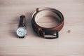 Wedding details, ideal groom accessories. .groom set with Belt, earring, Watches on wooden background. Concept of Men`s fashion