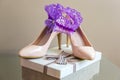 Wedding details. Purple Garter on Bride`s Slippers. Box with a gift