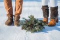 Wedding details, shoes of stylish wedding, wedding bouquet. pine-tree bouquet. brown shoes. close up. snowy road on the background