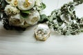 Wedding details. two classic gold wedding rings in a glass box and a bouquet of white flowers and greenery Royalty Free Stock Photo