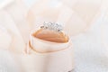 Wedding diamond ring on glossy background with beige ribbon Royalty Free Stock Photo