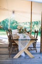 Wedding or dinner reception table, decorated in rustic style, outdoors in stylish tent. Reception on open air, rustic Royalty Free Stock Photo