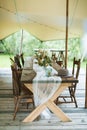 Wedding or dinner reception table, decorated in rustic style, outdoors in stylish tent. Reception on open air, rustic Royalty Free Stock Photo