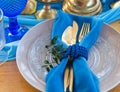 Wedding dinner table detail in white, gold and blue color. Selective focus. Royalty Free Stock Photo