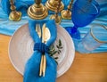 Wedding dinner table detail in white, gold and blue color. Selective focus. Royalty Free Stock Photo