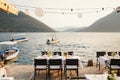 Wedding dinner table reception. Rectangular tables with white tablecloth, floral arrangements lemons in vases. Yellow