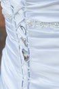 Wedding dress back laces with wedding rings Royalty Free Stock Photo