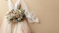 Wedding dress and bridal bouquet on neutral pastel background, copy space