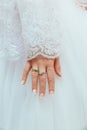 Wedding dress and bride's hands ring