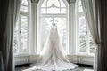 A wedding dress displayed against a tranquil winter scene, evoking anticipation and elegance with its intricate designs