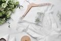 Beautiful wedding dress, engagement ring and flowers on white wooden background, flat lay Royalty Free Stock Photo