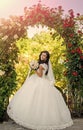 Wedding Dress. Fashionable woman posing. Bride with long brunette hair with flower. Royalty Free Stock Photo