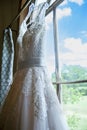 Wedding dress hanging awaiting the bride. Royalty Free Stock Photo