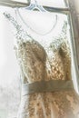 Wedding dress hanging awaiting the bride. Royalty Free Stock Photo