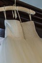 Wedding dress hanging awaiting the bride. Royalty Free Stock Photo