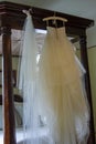 Wedding dress hanging awaiting the bride. Royalty Free Stock Photo