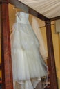 Wedding dress hanging awaiting the bride. Royalty Free Stock Photo