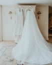 Wedding dress hanging on a rack in a bridal room