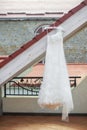 Wedding dress hanging on the roof of the balcony