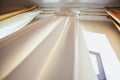 Wedding dress hanging up by next to window