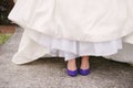 Wedding dress legs purple shoes.