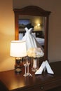 Wedding dress on a mannequin is reflected in the mirror against the background of shoes, bouquet and glasses. Royalty Free Stock Photo
