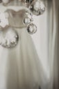 Wedding dress. White wedding dress with a full skirt on a hanger in the room of the bride with white curtains. Wedding Royalty Free Stock Photo