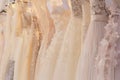 Wedding dresses hang on a hanger in a row