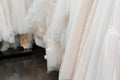 Wedding dresses made of silk chiffon, tulle and lace. Beautiful White cream bridal dress on hangers in wedding salon Royalty Free Stock Photo