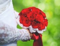 Wedding elegant bouquet of red rose flowers in hands bride Royalty Free Stock Photo