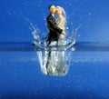 Wedding figurine falling down to blue water