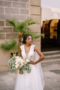 Wedding in Florence, Italy. African-American bride in a white dress and a long veil. With a magnificent bouquet of the