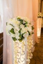 Wedding floristry. Arrangement of peonies on the high rack.