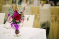Wedding flower bouquet in glass vase on guest table Royalty Free Stock Photo