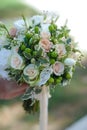 Wedding flower bouquet with pink roses in Bride Hand on Green Blurred Background. Royalty Free Stock Photo