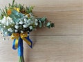 Wedding flowers, bridal bouquet wrapped with blue and yellow ribbons. Royalty Free Stock Photo