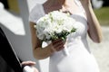 Wedding flowers in bride's hands closeup